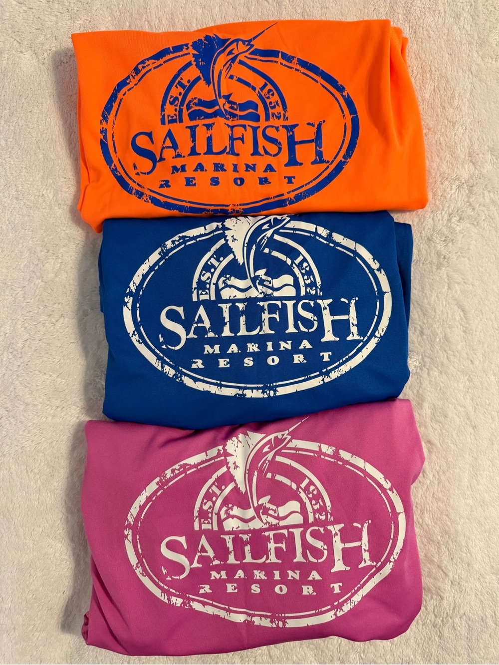 Sailfish Marina Resort Logo water shirts— Orange, Blue, Pink women’s size medium